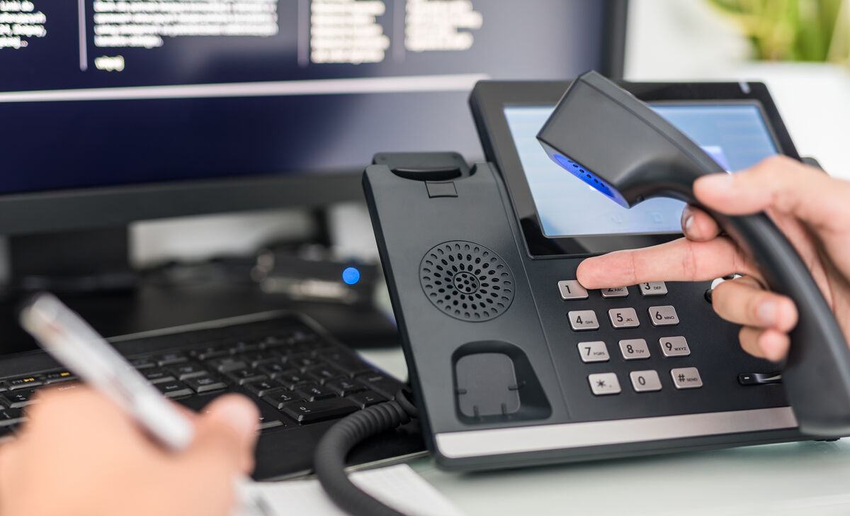 A Yealink VoIP desk phone on an office desk, the kind Talk2Me installs and supports across South Taranaki